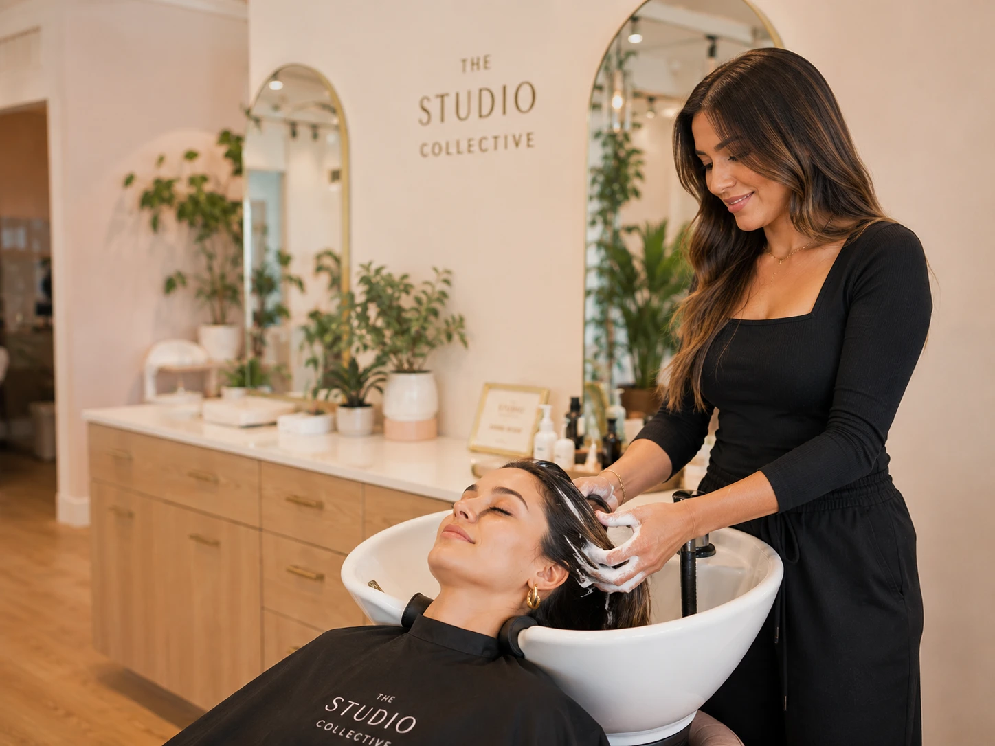 A stylist washing hair.